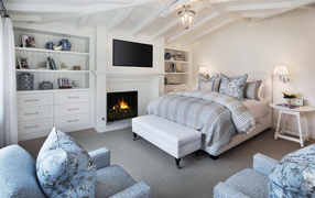 Cozy bedroom with furniture and fireplace