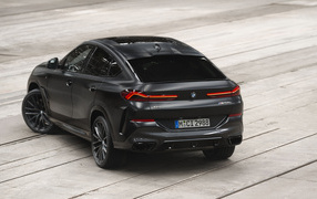 Stylish black car BMW X6 M50i, 2023 rear view