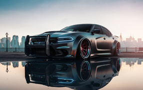 Dodge Charger Hellcat Enforcer car reflected in a puddle
