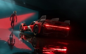 Красный спортивный автомобиль Ferrari 499P Modificata готовится к гонке