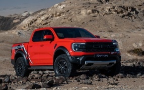 Red 2023 Ford Ranger Raptor pickup truck in the mountains