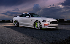 White car Ford Mustang GT against the sky