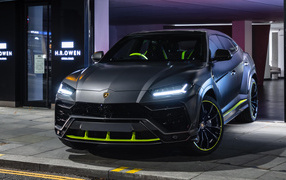 Silver Lamborghini Urus with headlights on