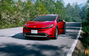 2023 Toyota Prius HEV red car on the road