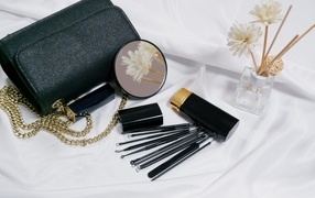 Cosmetics and handbag on the table