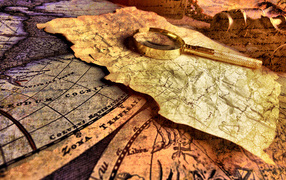 Magnifying glass and old map on the table