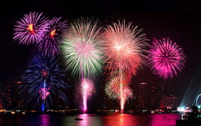 Multi-colored fireworks in the sky above the water