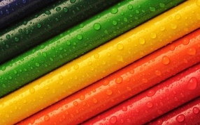 Разноцветные карандаши в каплях воды