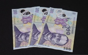 Three banknotes on a black background