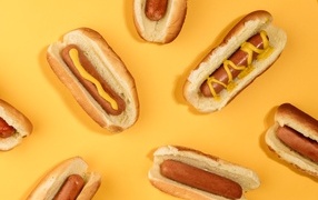 Appetizing hot dogs on a yellow table
