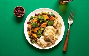 Baked vegetables with chicken on a green table