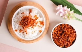 Rice with onions on a table with a flower