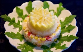 Salad on a plate with lemon and arugula