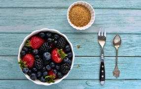 Appetizing ripe berries in a plate on the table