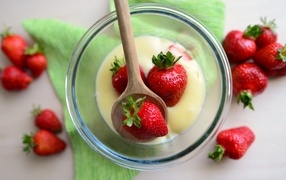 Delicious sweet strawberries in a glass with cream