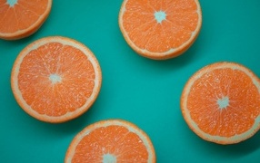 Halves of an orange on a blue background