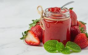 Jar of strawberry jam with fresh berries