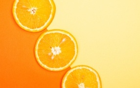 Кружочки апельсина на желтом фоне