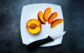 Sliced peach on a white plate
