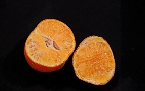 Tangerine on a black background close-up