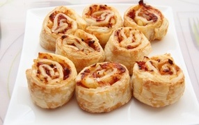 Puff pastry rolls with ham on a plate