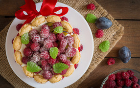 Cake with cream and raspberries with ribbon