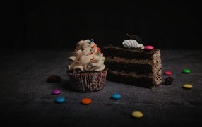 Кусок торта и кекс с кремом на столе