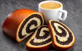 Poppy seed roll on table with coffee