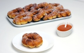 Sweet donuts in powdered sugar on the table