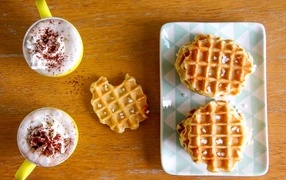Sweet waffles on the table with cappuccino