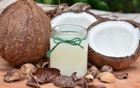 Coconut milk in a jar on a table with fruits