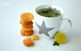 Cup of tea on the table with lemon and cookies