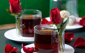 Two cups of tea with red roses
