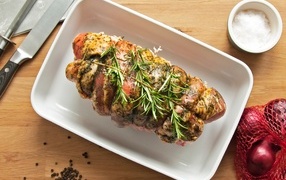 Baked meatloaf with rosemary sprigs