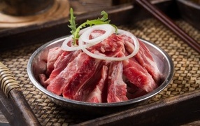 Fresh pork ribs with onions in a bowl