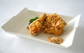 Fried crispy chicken in a plate on the table