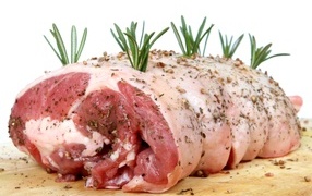 Large piece of meat with spices and rosemary
