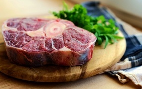 Steak on a wooden board with herbs