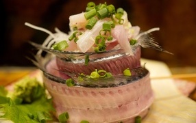 Herring fillet on the table with green onions