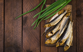 Herring fish on the table with green onions