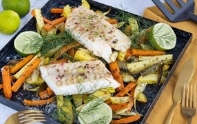 Pieces of fish on a baking sheet with vegetables