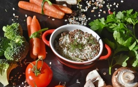 Rice on the table with carrots, tomatoes and mushrooms