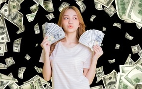 Девушка азиатка с долларами в руках