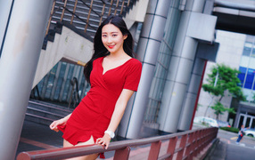 Cute smiling Asian woman in red dress