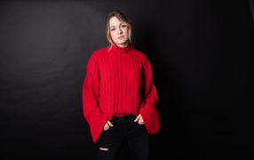 Girl in a red sweater on a black background