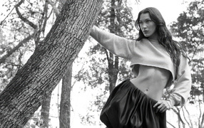 Model Bella Hadid stands by a tree in the park
