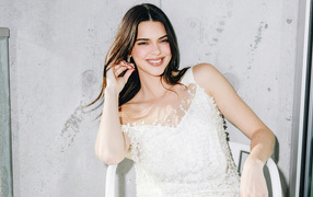 Smiling Kendall Jenner in white dress