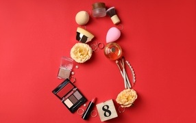 Cosmetics and jewelry on a red background as a gift for March 8