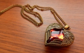 Beautiful heart-shaped pendant with a red stone