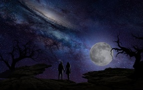 Couple in love against the backdrop of the moon and beautiful sky